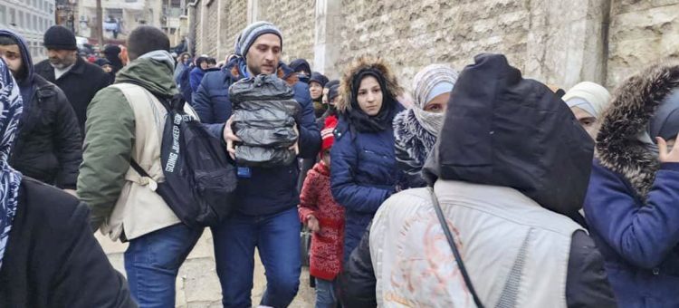 Syria, Aleppo, Aleppo Governorate, 6 February 2023 In the photo: Abdullah Al Shaghel, Field Monitor Assistant, distributing emergency food purchased by WFP to displaced people in Aleppo.