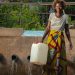 Mulher recolhe água numa fonte desenvolvida pelo Unicef na República Democrática do Congo - Foto: Unicef/Gwenn Dubourthoumi