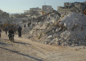 Moradores passam pelos escombros de edifícios desabados em Harém, na Síria, após o terremoto de fevereiro de 2023 - Foto: PMA